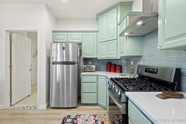 64 Floyd Everet, Colbert, OK 74733 - kitchen with appliances with stainless steel finishes, wall chimney range hood, green cabinetry, and light countertops