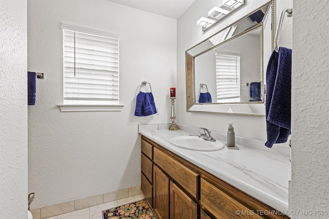 64 Floyd Everet, Colbert, OK 74733 - bathroom featuring plenty of natural light, vanity, and a textured wall