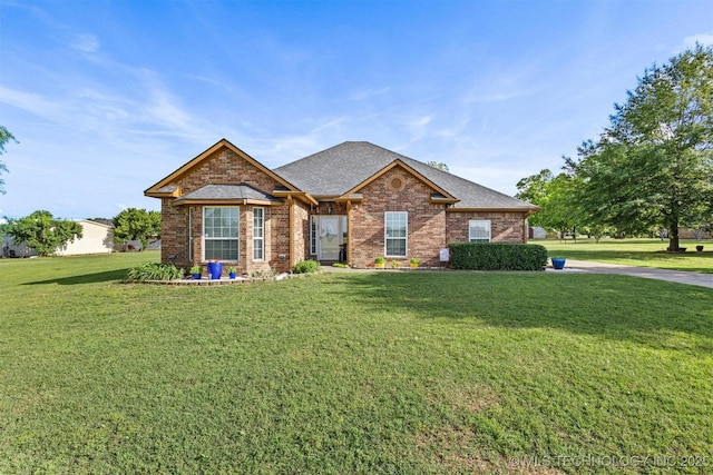 64 Floyd Everet, Colbert, OK 74733 - view of front of house featuring brick siding, a front yard, and roof with shingles