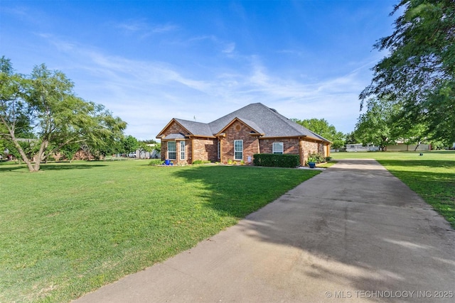 64 Floyd Everet, Colbert, OK 74733 - view of front of home with brick siding, a front lawn, concrete driveway, and roof with shingles