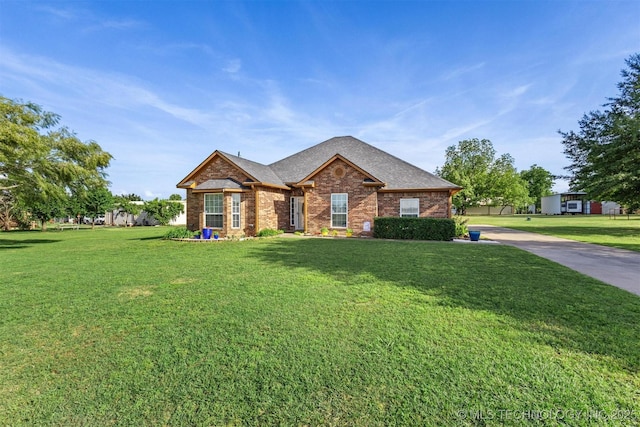 64 Floyd Everet, Colbert, OK 74733 - ranch-style home featuring brick siding, a front lawn, and a shingled roof