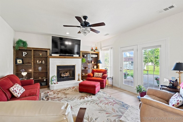 64 Floyd Everet, Colbert, OK 74733 - living room with ceiling fan, wood finished floors, and a fireplace