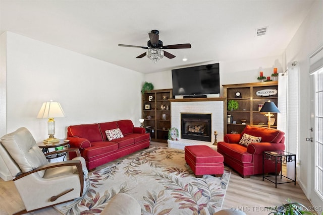 64 Floyd Everet, Colbert, OK 74733 - living room with ceiling fan, wood finished floors, and a fireplace