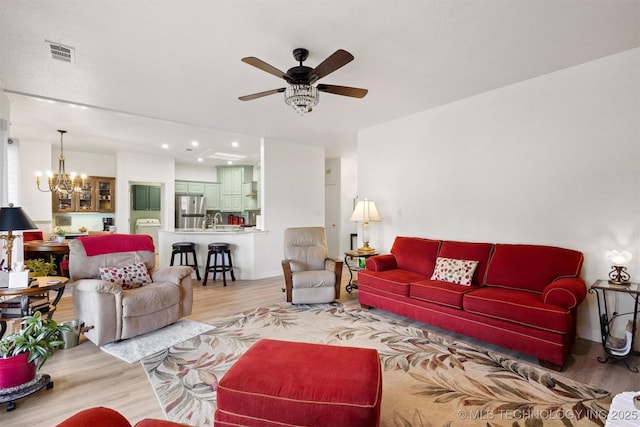 64 Floyd Everet, Colbert, OK 74733 - living area with a chandelier, wood finished floors, ceiling fan, baseboards, and washer / clothes dryer