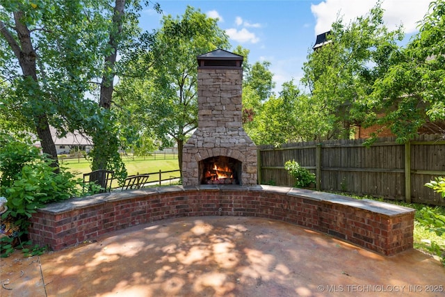 7040 E 127th St, Bixby, OK 74008 - view of patio / terrace with an outdoor stone fireplace