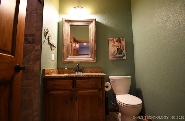 96729 S 4490, Vian, OK 74962 - half bathroom featuring toilet, vanity, and a textured wall