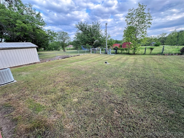 924 9th Ave SE, Ardmore, OK 73401 - view of yard featuring an outbuilding and central AC unit