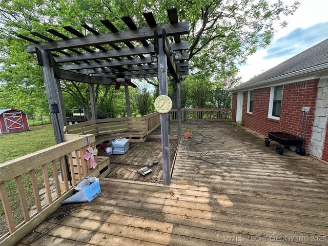 924 9th Ave SE, Ardmore, OK 73401 - wooden deck featuring a pergola, a yard, an outbuilding, and a shed