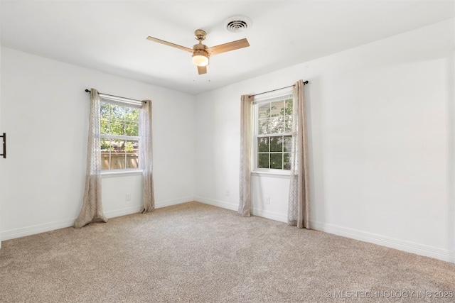 unfurnished room featuring ceiling fan, carpet flooring, and baseboards