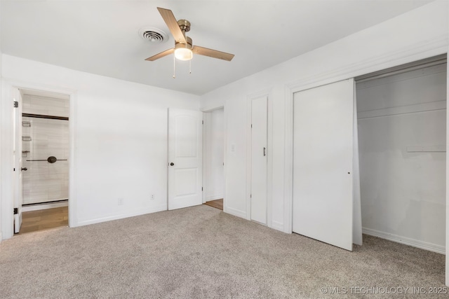 unfurnished bedroom featuring carpet, connected bathroom, baseboards, and a closet