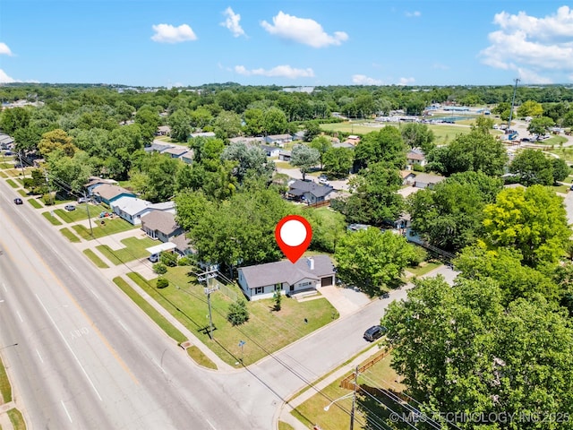 aerial view of residential area featuring a tree filled landscape