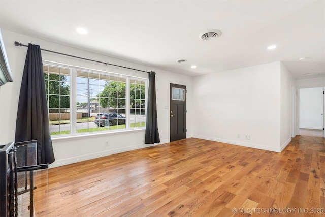 unfurnished living room featuring baseboards, light wood finished floors, and recessed lighting