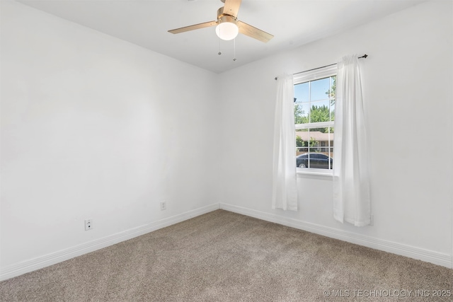 carpeted empty room with ceiling fan and baseboards