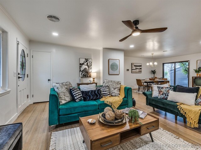 2528 E 57th St, Tulsa, OK 74105 - living room featuring ceiling fan, light wood finished floors, a chandelier, recessed lighting, and baseboards
