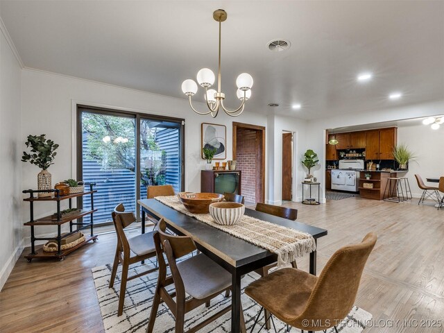 2528 E 57th St, Tulsa, OK 74105 - dining area with ornamental molding, baseboards, light wood-style floors, a chandelier, and recessed lighting