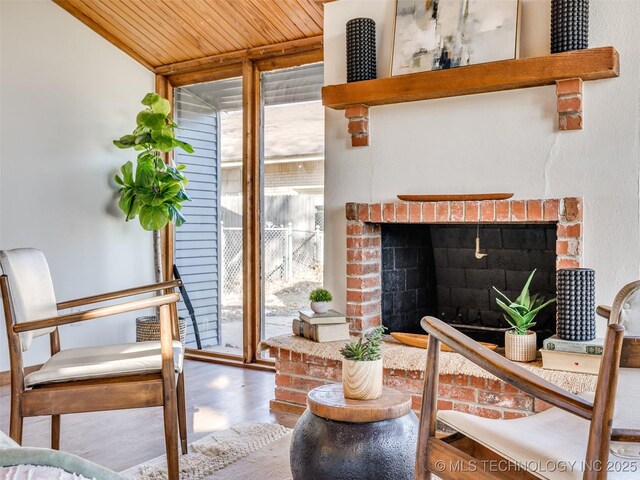 2528 E 57th St, Tulsa, OK 74105 - living room featuring a wall of windows, wooden ceiling, wood finished floors, and a fireplace