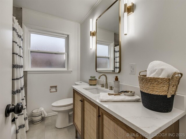 2528 E 57th St, Tulsa, OK 74105 - bathroom with toilet, ornamental molding, plenty of natural light, vanity, and a shower with curtain