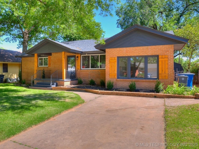 2528 E 57th St, Tulsa, OK 74105 - view of front of house featuring brick siding and a front lawn