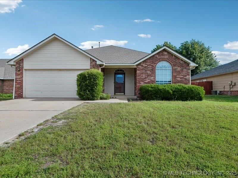 1021 W 117th St S, Jenks, OK 74037 - ranch-style house featuring brick siding, a garage, a front lawn, concrete driveway, and central air condition unit