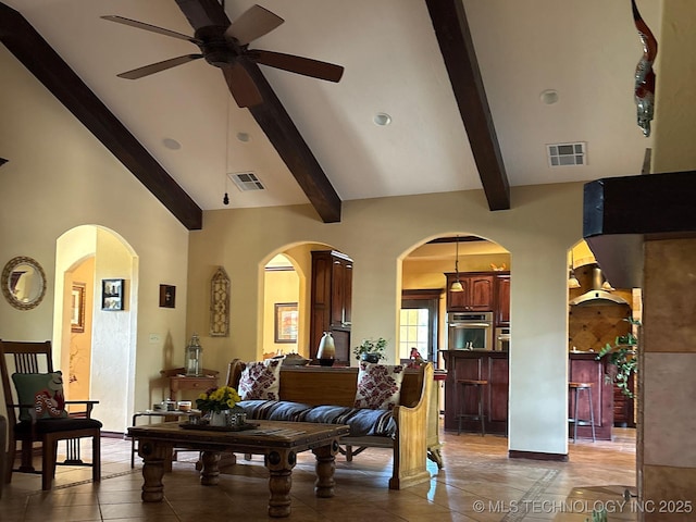1216 N Oak Grove Rd, Drumright, OK 74030 - living area with a ceiling fan, beamed ceiling, arched walkways, and light tile patterned floors