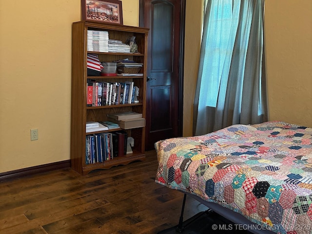 1216 N Oak Grove Rd, Drumright, OK 74030 - bedroom with dark wood-style flooring and baseboards