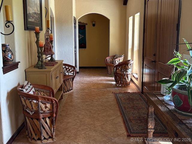 1216 N Oak Grove Rd, Drumright, OK 74030 - corridor with arched walkways, tile patterned flooring, and baseboards