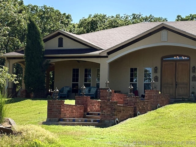 1216 N Oak Grove Rd, Drumright, OK 74030 - view of front facade with stucco siding, a front yard, and a shingled roof