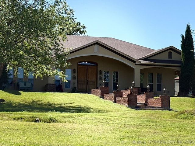 1216 N Oak Grove Rd, Drumright, OK 74030 - rear view of house with a lawn, stucco siding, and a shingled roof