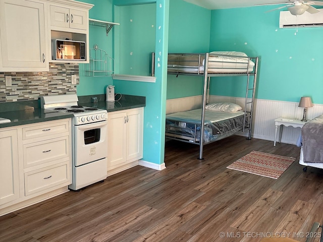 1216 N Oak Grove Rd, Drumright, OK 74030 - kitchen featuring white range with electric stovetop, built in microwave, an AC wall unit, a ceiling fan, and dark countertops