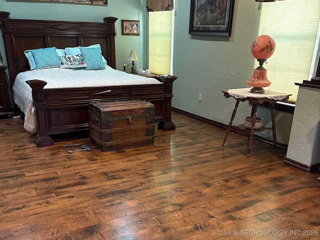 1216 N Oak Grove Rd, Drumright, OK 74030 - bedroom with dark wood finished floors, baseboards, and a textured wall
