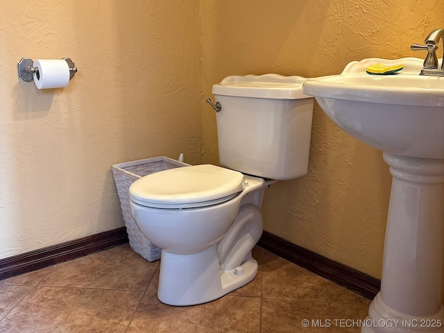 1216 N Oak Grove Rd, Drumright, OK 74030 - bathroom with toilet, baseboards, and tile patterned floors