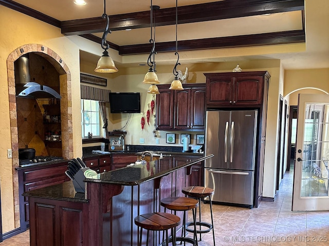 1216 N Oak Grove Rd, Drumright, OK 74030 - kitchen with freestanding refrigerator, ornamental molding, arched walkways, light tile patterned floors, and a kitchen bar
