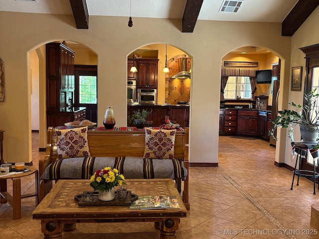 1216 N Oak Grove Rd, Drumright, OK 74030 - dining space with beam ceiling, light tile patterned floors, healthy amount of natural light, and arched walkways