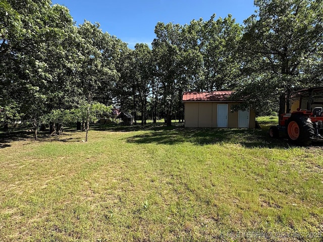 1216 N Oak Grove Rd, Drumright, OK 74030 - view of green lawn with a storage unit and an outbuilding