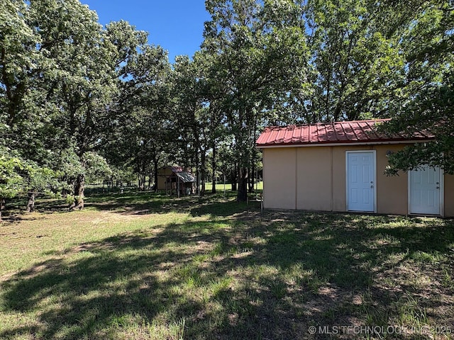 1216 N Oak Grove Rd, Drumright, OK 74030 - view of grassy yard featuring a storage unit and an outbuilding