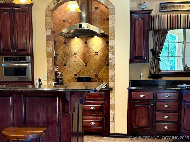 1216 N Oak Grove Rd, Drumright, OK 74030 - indoor wet bar with stainless steel oven, island range hood, and a textured wall