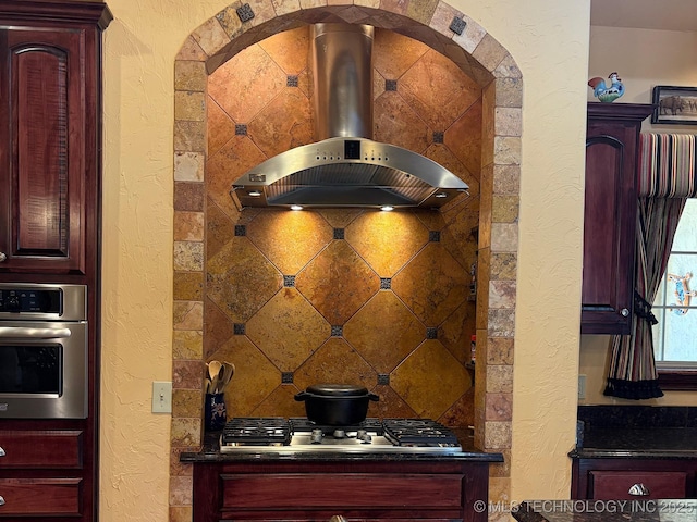 1216 N Oak Grove Rd, Drumright, OK 74030 - kitchen with appliances with stainless steel finishes, island exhaust hood, a textured wall, dark brown cabinets, and dark countertops