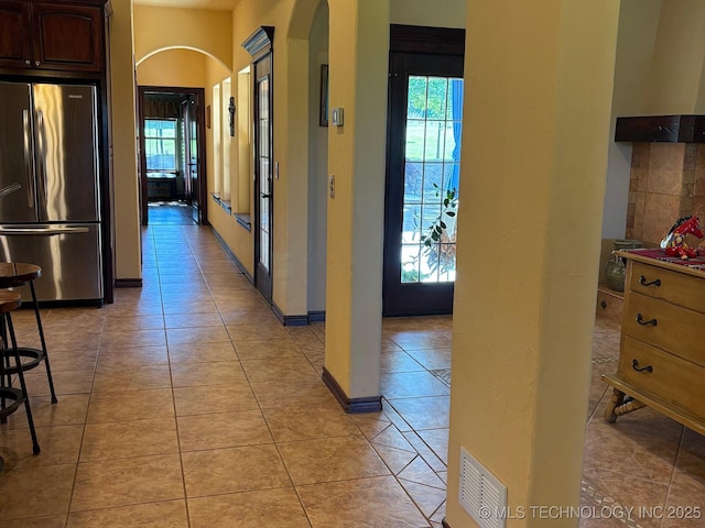 1216 N Oak Grove Rd, Drumright, OK 74030 - hallway featuring arched walkways, healthy amount of natural light, and light tile patterned flooring
