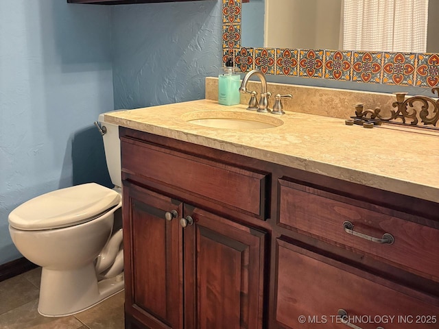 1216 N Oak Grove Rd, Drumright, OK 74030 - bathroom with vanity, toilet, tile patterned floors, and a textured wall