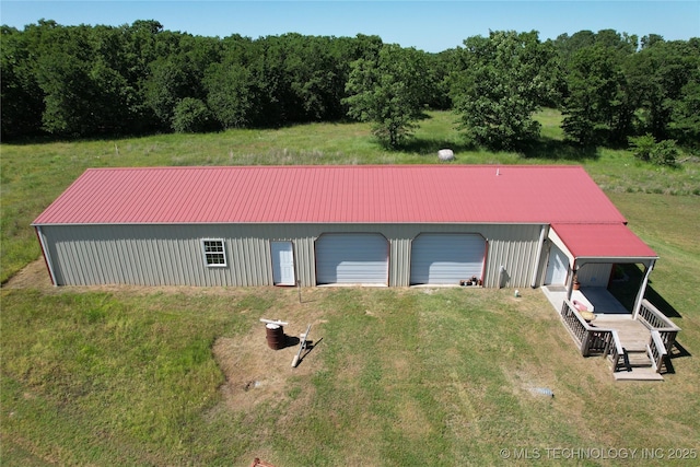 1216 N Oak Grove Rd, Drumright, OK 74030 - view of front of house with a detached garage, an outdoor structure, metal roof, an outbuilding, and a front yard