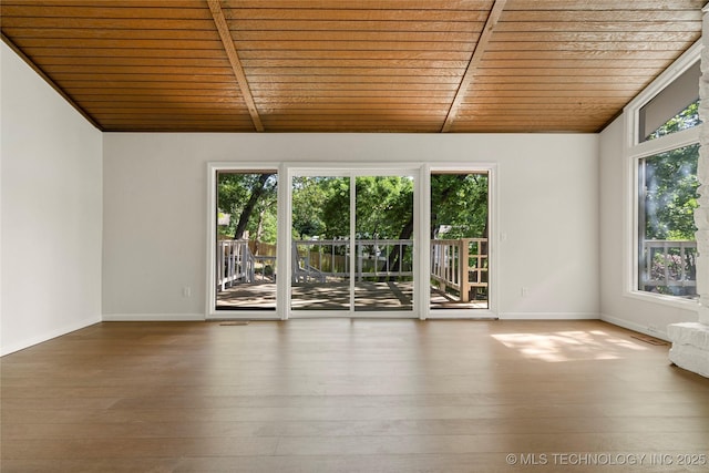 3442 E 75th Pl, Tulsa, OK 74136 - spare room featuring wood ceiling, vaulted ceiling, wood-type flooring, and baseboards