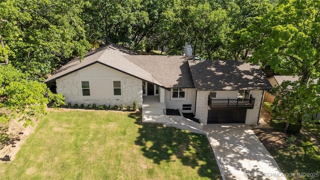 3442 E 75th Pl, Tulsa, OK 74136 - view of front of home featuring stone siding, roof with shingles, a front yard, driveway, and a balcony