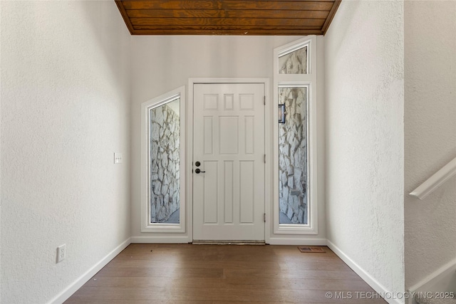 3442 E 75th Pl, Tulsa, OK 74136 - entryway with a textured wall, baseboards, wood finished floors, and wooden ceiling