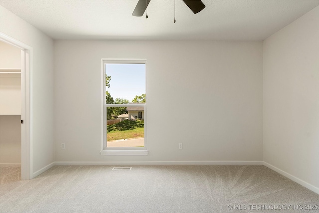 3442 E 75th Pl, Tulsa, OK 74136 - spare room with light colored carpet, a ceiling fan, and baseboards