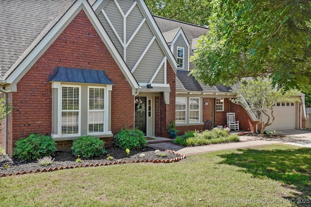 3606 E 70th Pl, Tulsa, OK 74136 - tudor home featuring brick siding, driveway, a front lawn, an attached garage, and roof with shingles