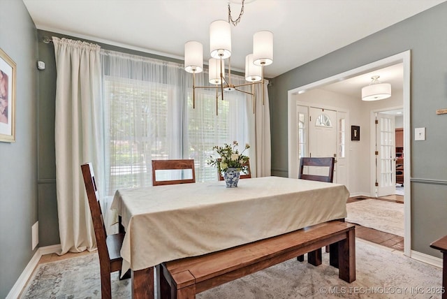 3606 E 70th Pl, Tulsa, OK 74136 - dining room featuring a chandelier and baseboards
