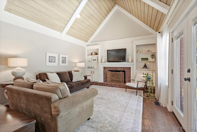 3606 E 70th Pl, Tulsa, OK 74136 - living area with hardwood / wood-style flooring, wooden ceiling, a brick fireplace, and built in features
