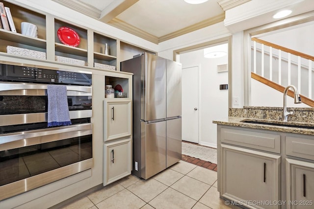 3606 E 70th Pl, Tulsa, OK 74136 - kitchen with appliances with stainless steel finishes, a sink, open shelves, ornamental molding, and light tile patterned floors