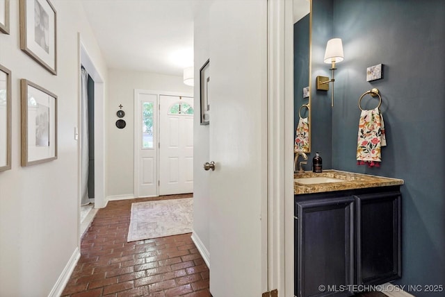 3606 E 70th Pl, Tulsa, OK 74136 - foyer entrance featuring brick flooring, baseboards, and bar area
