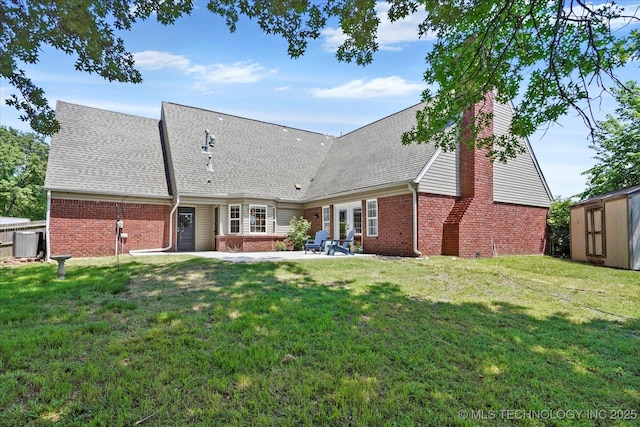 3606 E 70th Pl, Tulsa, OK 74136 - rear view of house with brick siding, a patio, a yard, central air condition unit, and a shingled roof